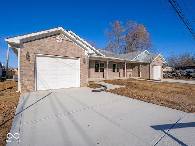 ranch-style home featuring a porch and a garage