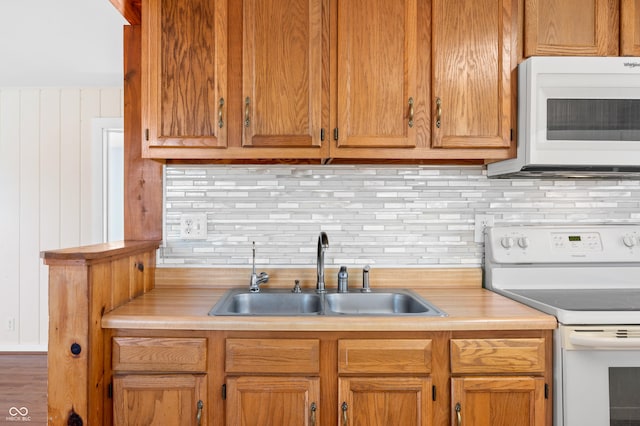 100 N Jefferson St, Nashville, IN 47448 - kitchen featuring white appliances, decorative backsplash, and light countertops