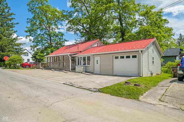 100 N Jefferson St, Nashville, IN 47448 - view of front of property featuring an attached garage and a metal roof