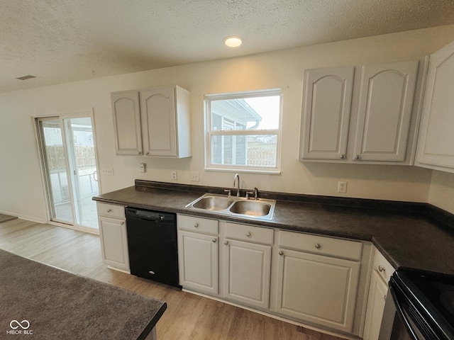 kitchen featuring sink, light hardwood / wood-style flooring, plenty of natural light, black dishwasher, and white cabinets