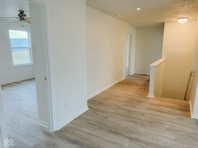 hallway with light hardwood / wood-style flooring