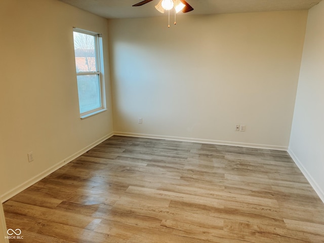 spare room featuring light hardwood / wood-style floors and ceiling fan