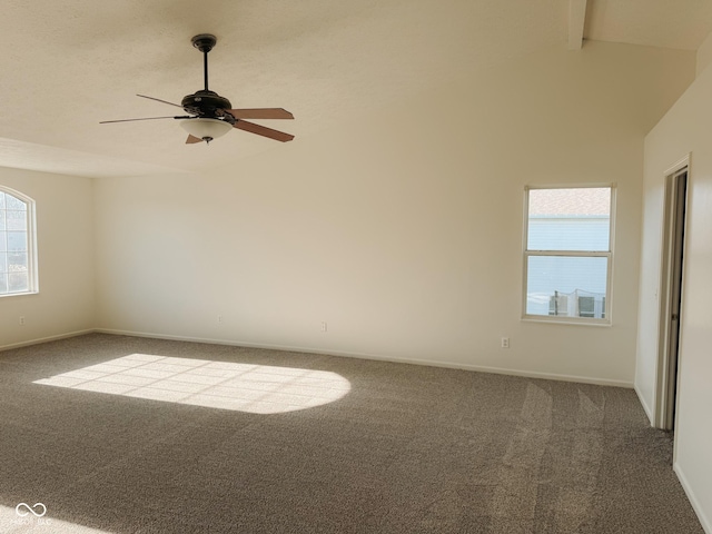 empty room featuring ceiling fan, carpet flooring, and vaulted ceiling with beams