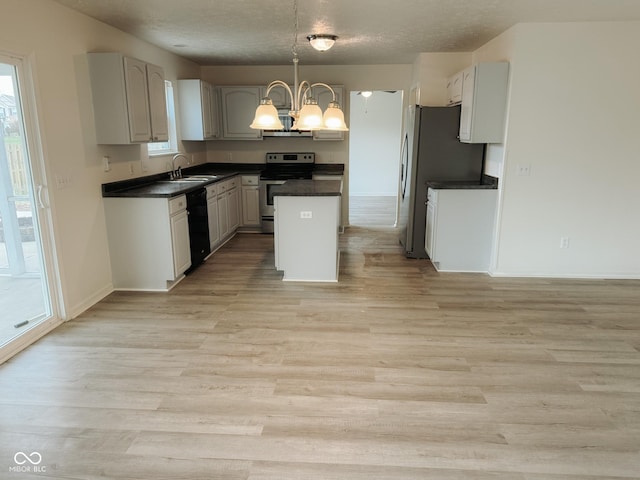 kitchen with sink, gray cabinetry, a chandelier, a center island, and stainless steel appliances