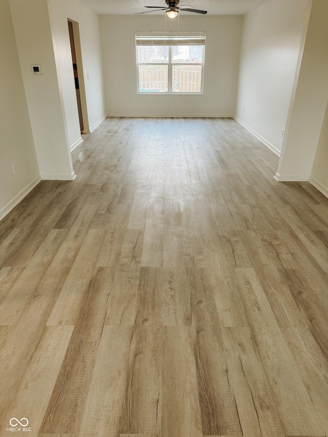 spare room featuring light hardwood / wood-style floors and ceiling fan