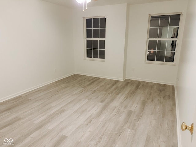 spare room featuring light hardwood / wood-style flooring and ceiling fan