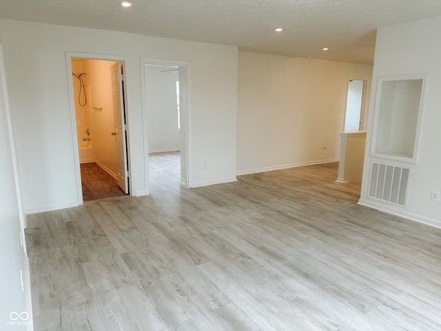 empty room with light hardwood / wood-style flooring