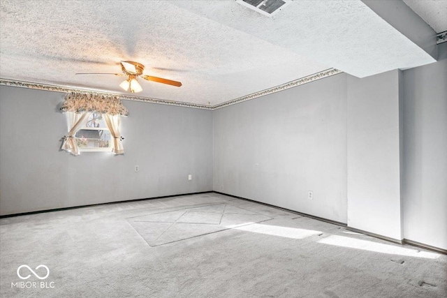 empty room with light carpet, a textured ceiling, and ceiling fan