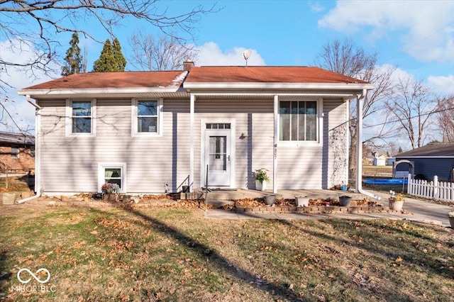 rear view of property with a lawn