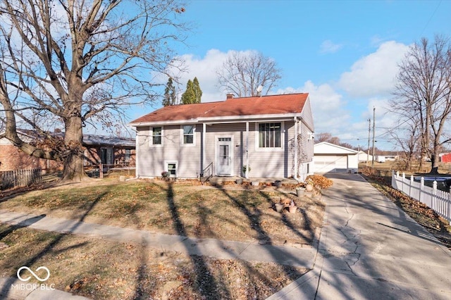 view of front of home with a garage and an outdoor structure