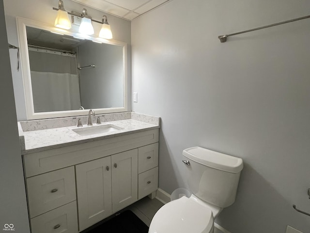 bathroom featuring vanity, toilet, and curtained shower