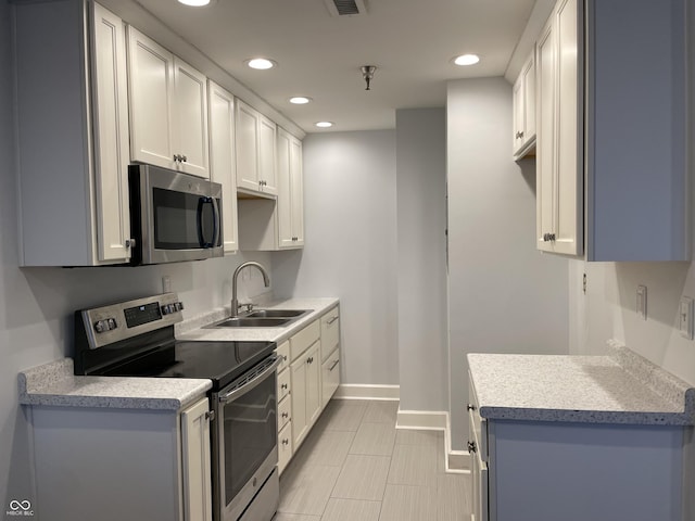 kitchen with sink, white cabinets, and stainless steel appliances