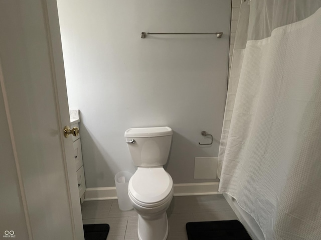 bathroom with tile patterned floors, vanity, toilet, and walk in shower