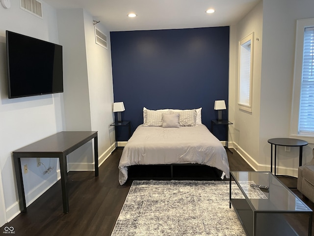 bedroom with dark wood-type flooring