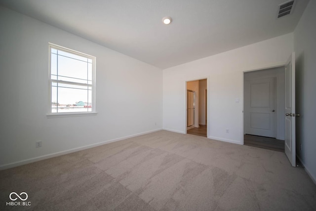 unfurnished bedroom with light carpet