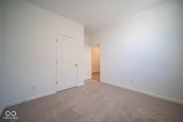 unfurnished room with light colored carpet