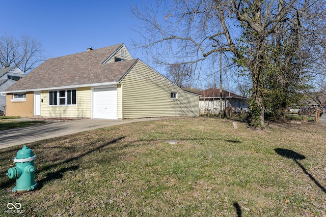 view of side of home featuring a yard and a garage