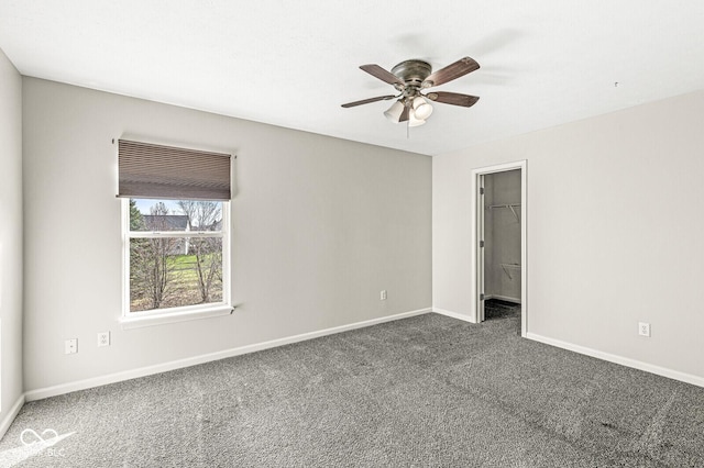 empty room with a ceiling fan, carpet, and baseboards