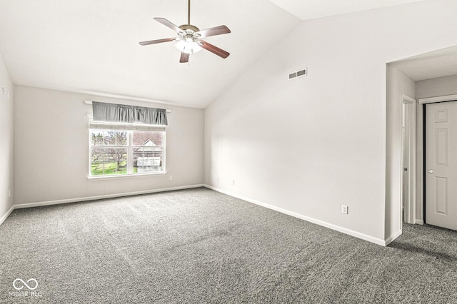 spare room featuring lofted ceiling, ceiling fan, carpet flooring, visible vents, and baseboards