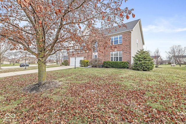 view of front of property with a garage, concrete driveway, brick siding, and a front lawn