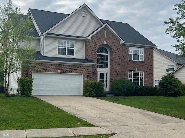 view of front of property with brick siding, driveway, an attached garage, and a front yard