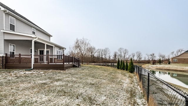 view of yard with a deck with water view