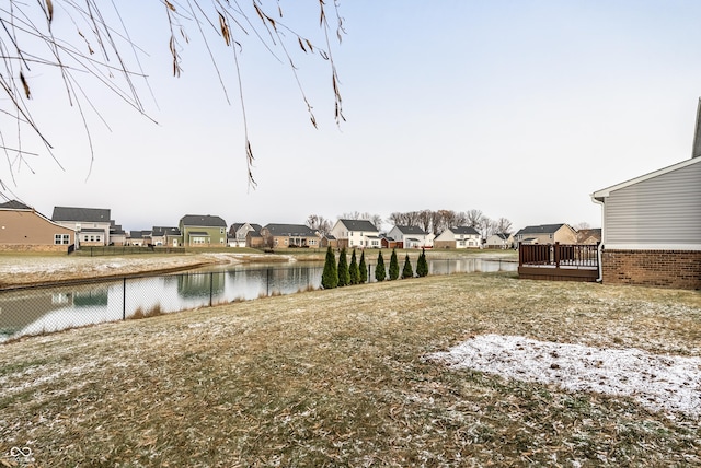 view of yard with a deck with water view