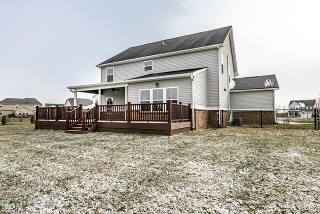 rear view of house with ceiling fan and a deck