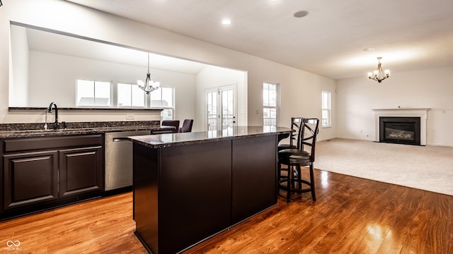 kitchen with stainless steel dishwasher, a center island, sink, and a wealth of natural light