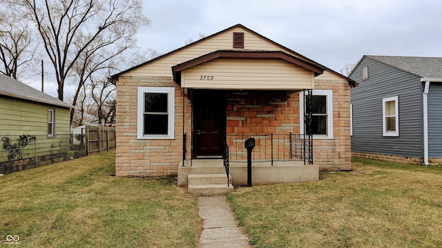 bungalow-style house featuring a front lawn