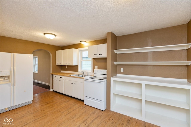 kitchen featuring white cabinets, white appliances, light hardwood / wood-style flooring, and sink