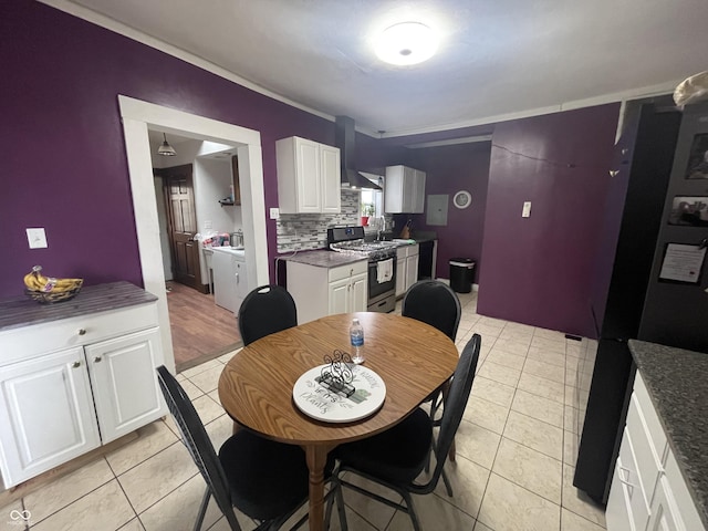 dining room featuring sink, washing machine and dryer, and light tile patterned flooring