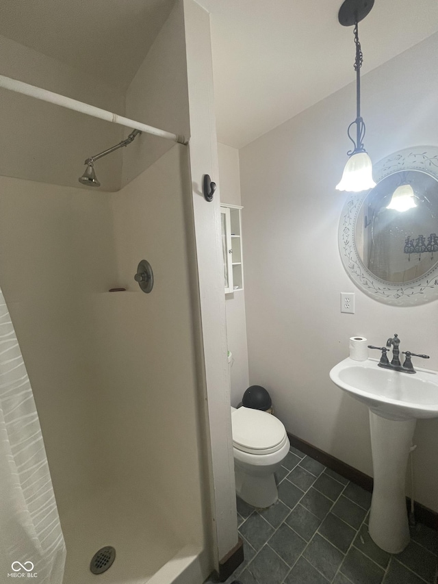 bathroom featuring tile patterned floors, sink, toilet, and walk in shower