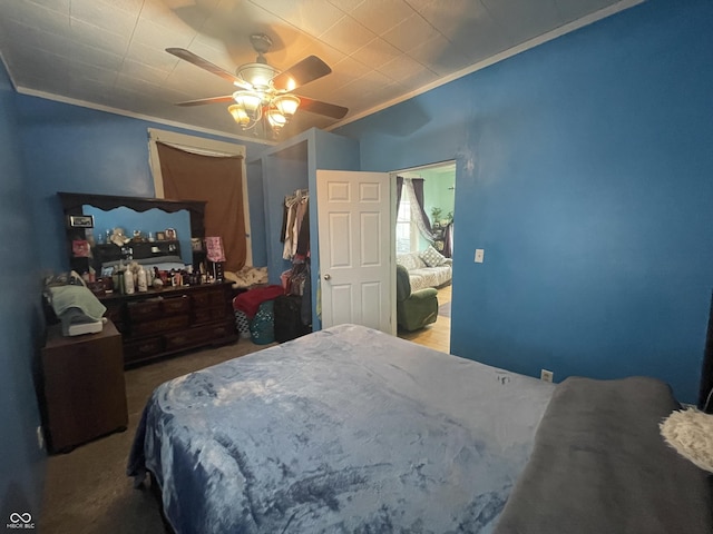 bedroom with carpet flooring, ceiling fan, and ornamental molding