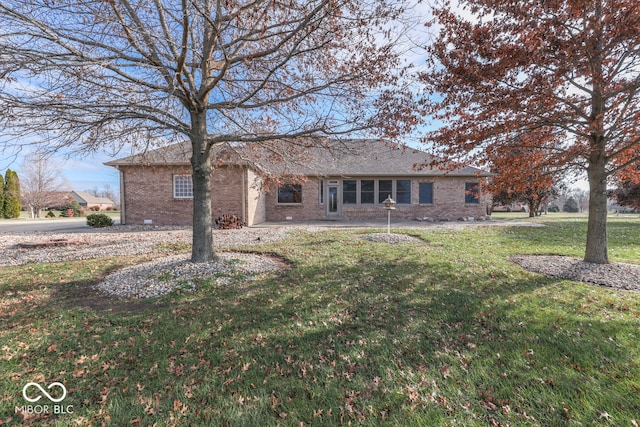 rear view of house featuring a yard