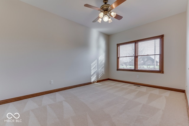 spare room with light carpet and ceiling fan