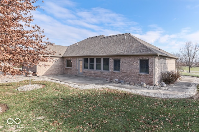 back of property featuring a yard and a patio