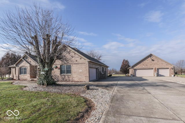 exterior space with driveway and brick siding