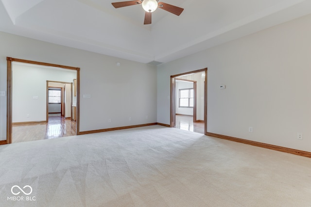 carpeted empty room featuring ceiling fan