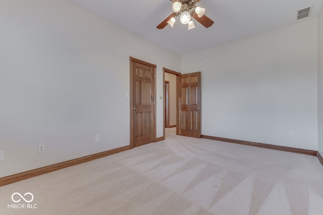 carpeted empty room featuring ceiling fan