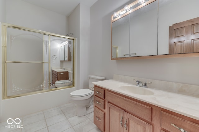 full bathroom with tile patterned flooring, vanity, toilet, and combined bath / shower with glass door