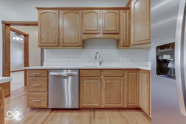 kitchen with ceiling fan, sink, light brown cabinets, stainless steel appliances, and light hardwood / wood-style floors