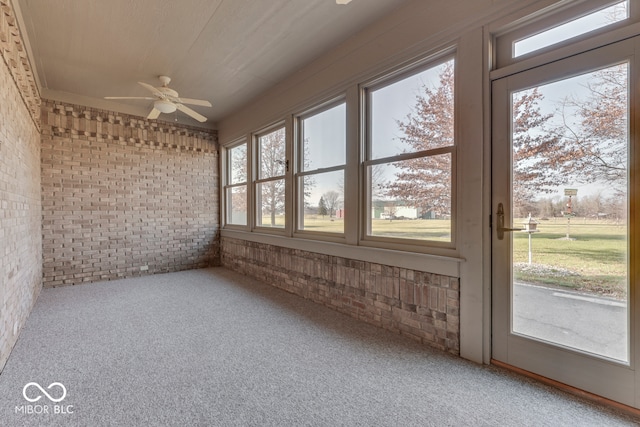 unfurnished sunroom with plenty of natural light and ceiling fan