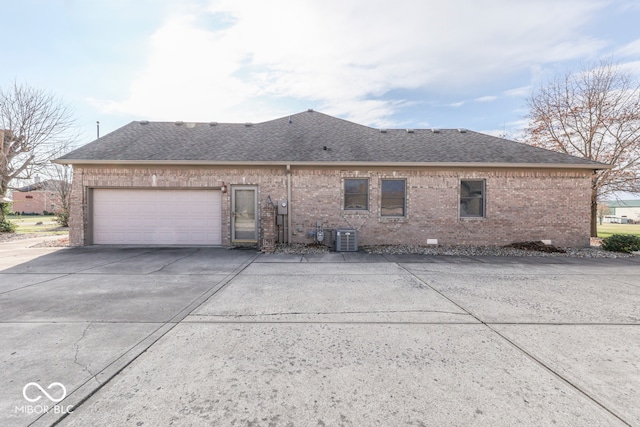 exterior space with a garage and central AC