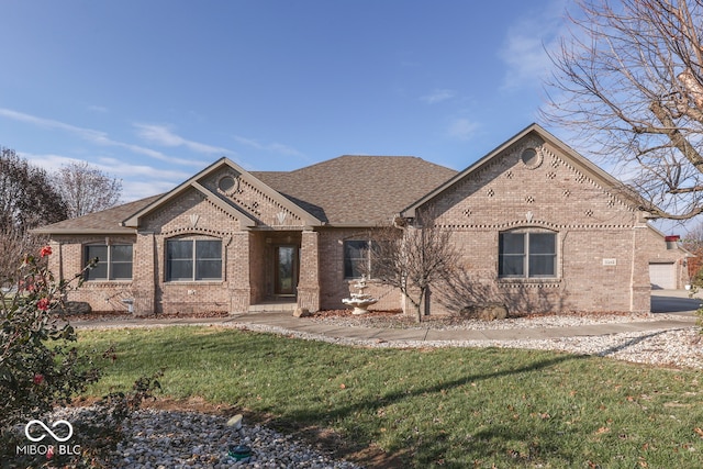 view of front facade featuring brick siding, a front lawn, and a shingled roof