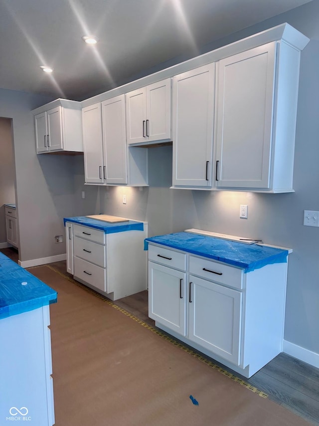 kitchen with white cabinets and light wood-type flooring