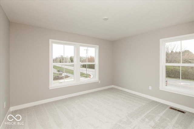 6973 Oakdale Ln, Avon, IN 46123 - spare room with visible vents, baseboards, a wealth of natural light, and carpet floors