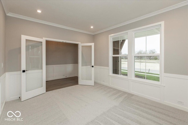 6973 Oakdale Ln, Avon, IN 46123 - unfurnished bedroom featuring french doors, a decorative wall, ornamental molding, and carpet floors