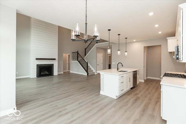 6973 Oakdale Ln, Avon, IN 46123 - kitchen with an inviting chandelier, recessed lighting, light wood-style flooring, white cabinets, and stainless steel appliances