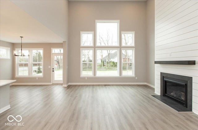 6973 Oakdale Ln, Avon, IN 46123 - unfurnished living room featuring wood finished floors, a fireplace, and baseboards